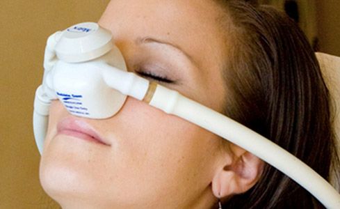 Woman with nitrous oxide dental sedation nasal mask