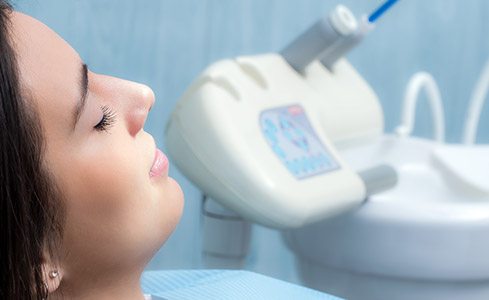 Woman under oral conscious dental sedation with eyes closed