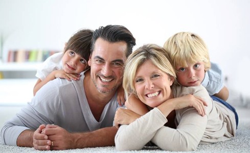 Portrait of a happy family after dental visit using calaject pain free local anesthesia