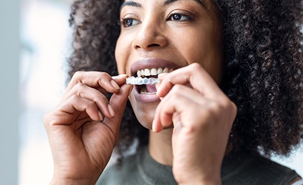 Woman putting in Invisalign tray